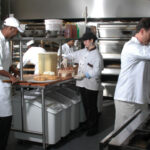 Five employees working in a kitchen - Colorado Pest Management
