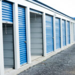 A series of storage units with blue doors - Colorado Pest Management