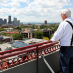 Colorado Pest Management employee on roof, looking at downtown Denver