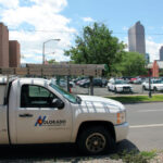 A white Colorado Pest Management truck parked on the street