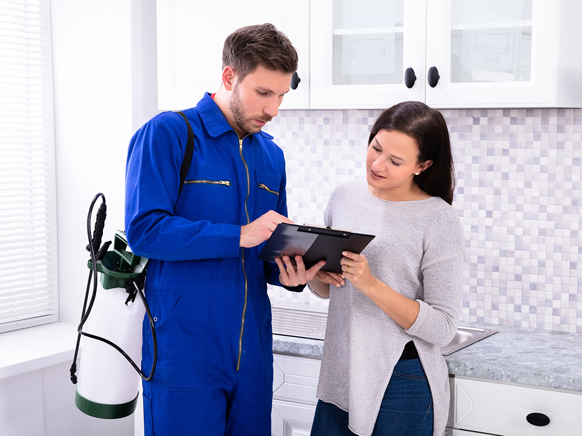 A pest control expert speaking with a homeowner
