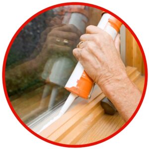 person sealing windows
