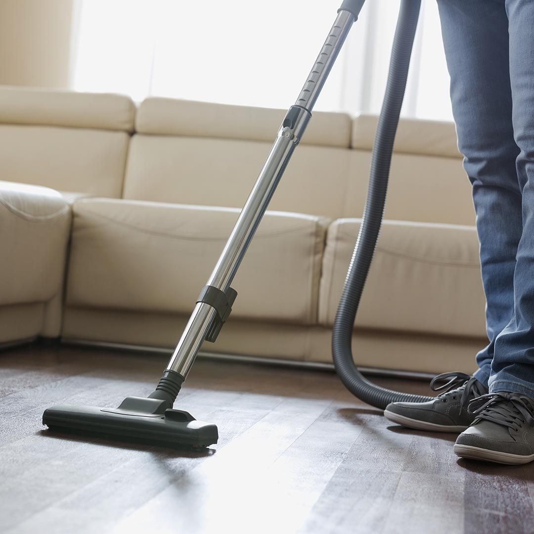 Person vacuuming living room floor