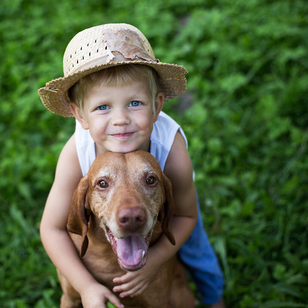 young child and dog outside