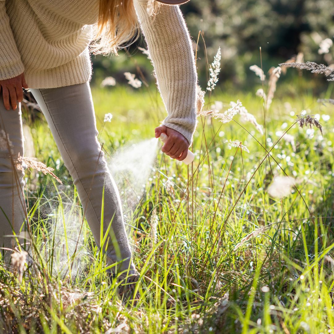 woman putting on tick repellent 