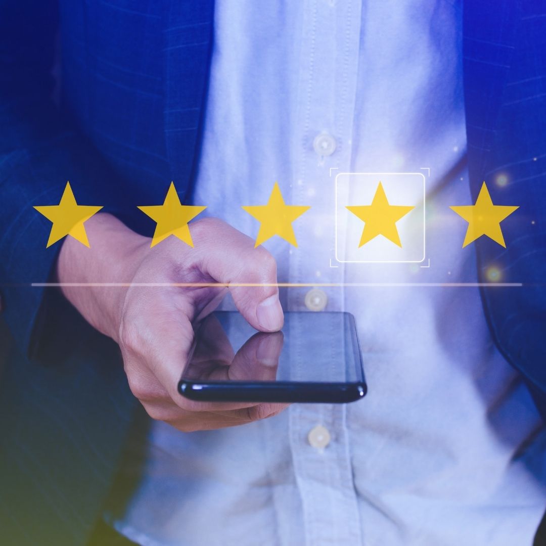 A smartphone screen showing a 5-star rating and positive review for a short-term rental.